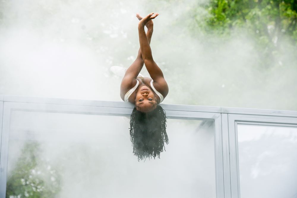 dancer on top of perspex glass box