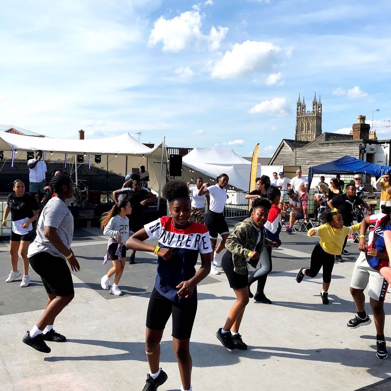 a group of young dancers perform the high energy 'Session' on a car park roof in the middle of a sunny afternoon