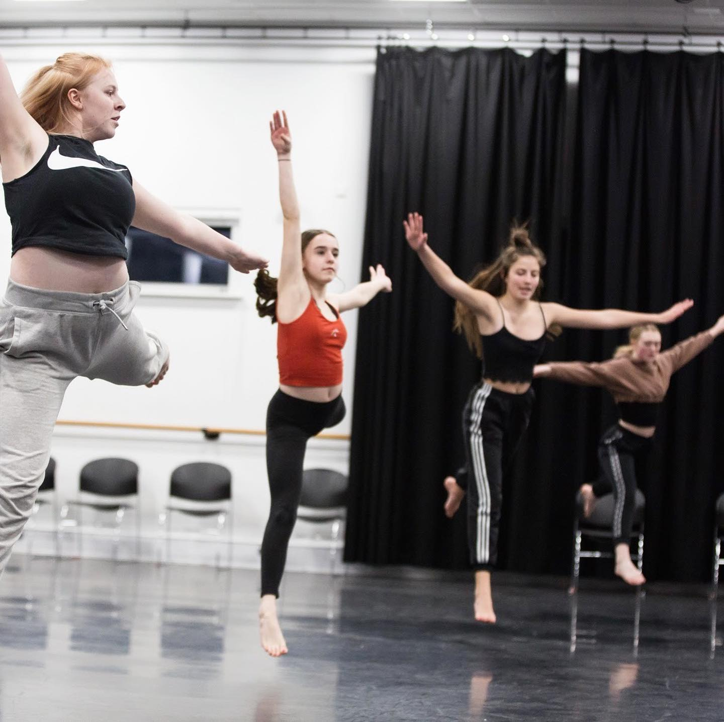 members of the Strike A Light Youth Dance Company rehearsing a routine in a dance studio